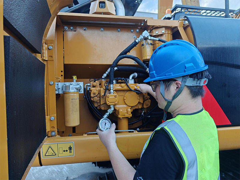 Engineers inspect the hydraulic pump